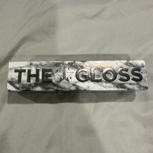 Jeffree Star “The Gloss” color is “heaven’s gate.” Brand new in box.